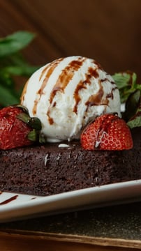 Decadent American Chocolate Fudge Brownie Topped With Ice Cream